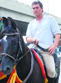 Oliver Cockidge Bolen Briars rides a horse on NH-1 in Panipat.