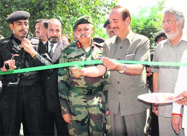 Jammu and Kashmir Chief Minister Ghulam Nabi Azad cuts the ribbon to inaugurate the 284m-long Bemina Bridge in Srinagar on Saturday. 