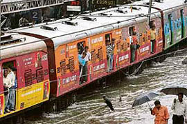 A train moves through a flooded line after heavy rain lashed Mumbai on Saturday.