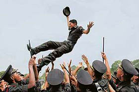 Gentlemen cadets throw one of their colleagues into the air as a mark of joy after the passing-out parade of the Indian Military Academy, Dehra Dun, on Saturday.