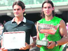 Spains Rafael Nadal (R) and Swiss Roger Federer hold their trophies after the final of the French Open at Roland Garros, in Paris, on Sunday. Nadal won 6-1, 6-3, 6-0. 