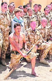 US First Lady Laura Bush poses with New Zealand military personnel after watching their traditional New Zealand arrival dance at the Bamiyan Provincial Reconstruction Team Base, controlled by the New Zealand military, during a surprise visit to Bamiyan on Sunday.