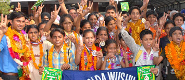 The Bathinda Wushu team celebrates its victory on arrival at the Bathinda railway station.