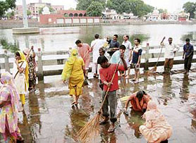 Operation clean-up in progress on the ghats of the Sannihit Sarovar in Kurukshetra.