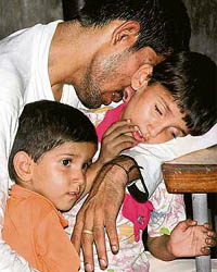 Subhash, husband of Sarita, with his two daughters Muskan and Heena at the PGI, Chandigarh, on Monday.