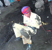 A cop struggles to get on his feet after falling into a mud pool near Damoria bridge in Jalandhar on Monday.