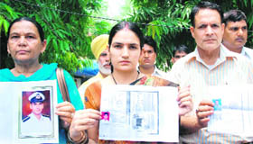 Relatives of missing sailors during a dharna in New Delhi on Monday.