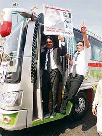 Lawyers gesture from a bus before the start of a cross-country rally in Karachi on Monday.