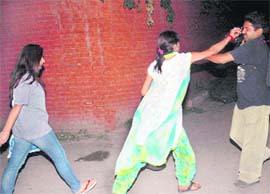 Sister of Noor Kataria tries to snatch the camera of a mediaperson outside Burail Jail, Chandigarh, on Tuesday. 