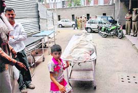 Saritas daughter with the body of her mother outside the PGI mortuary in Chandigarh on Tuesday.
