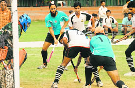 Players in action during semi-final match between IOC and BPCL in Sixth Olympian Dharam Singh Memorial Hockey Tournament at Hockey Stadium, Sector 18, in Chandigarh on Wednesday.