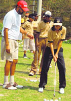 Coach Jessie Grewal gives tips to junior golfers at the national camp being held at the CJA Golf Range in Chandigarh on Wednesday. 