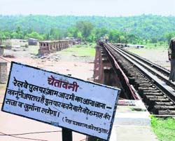 The flooded Chaki rivulet which washed away the vital connecting link between Kangra and Pathankot early on Wednesday.