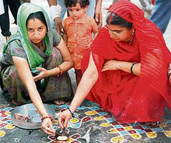 Kashmiri Pandit women light candles during an annual festival at the shrine of Khir Bhawani, about 30 km from Srinagar, on Wednesday.