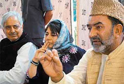 PDP patron Mufti Mohammed Syeed, president Mehbooba Mufti(C) and Mohd Yaqoob address a press conference in Srinagar on Wednesday.
