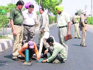 Chief parliamentary secretary Harish Rai Dhanda inspects Chandigarh road in Ludhiana on Wednesday.