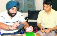 Muktsar SSP Gurpreet Singh Gill shows the timer that was found on the Abohar-Jodhpur Express at Malout on Wednesday.