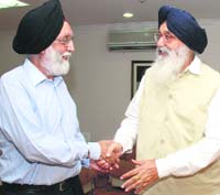 Punjab Chief Minister Prakash Singh Badal (R) speaks to Union Minister for Sports M.S.Gill at a meeting in New Delhi on Wednesday. 