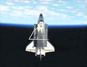 Space shuttle Discovery is in full view with the earth in the background after undocking from the International Space Station in this image from NASA TV on Wednesday 