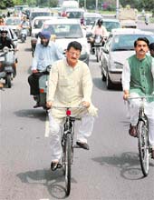 Punjab transport minister Master Mohan Lal protests against the hike in fuel prices by going to his office on a bicycle in Chandigarh on Thursday