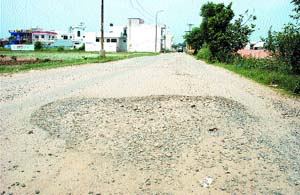 The potholed Ladhewali-Nangal Shama road is a commuters nightmare. 