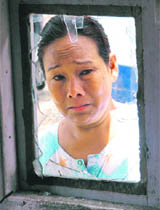 Dilmaya Dhungo (48) cries after her house was broken into by supporters of the ruling CPM during a 48-hour strike called against the Gorkha Janmukhi Morcha, which is demanding a separate state, in Siliguri on Thursday.