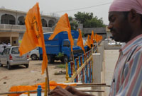 An activist of the ruling SAD (B) putting up flags of the party on the premises of Gurdwara Haji Rattan in Bathinda on Friday.