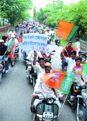 Activists of the Delhi BJP Youth Morcha take out a scooter rally from the Rajghat against the rise in the prices of fuel and essential commodities in New Delhi on Friday. Tribune photo:Manas Ranjan Bhui