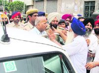 SAD leader Amarjit Singh Bhatia (R) argues with joint commissioner Ashok Bajaj after some shops were demolished by the MC in Ludhiana on Friday.