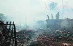 Delhi fire officials douse the flames in slums near Sadar Bazar on Saturday. Around 25 jhuggis were destroyed in the fire.