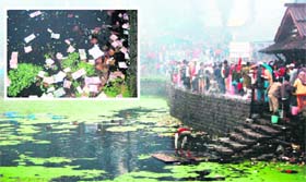 A view of the fair on the banks of Kamrunag Lake on the Mandi-Karsog road on Saturday; and (inset) the currency offered by devotees