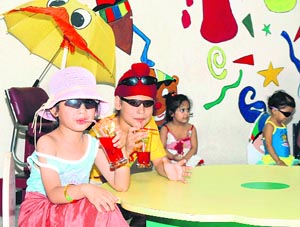 Tiny tots enjoy a beach party during a summer camp organised by Maple Bear Nursery School in Ludhiana on Saturday. 