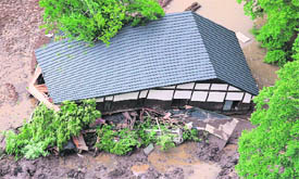 A house damaged in a landslide caused by the earthquake in Kurihara, Miyagi prefecture. A powerful earthquake struck northern Japan, killing four persons and injuring more than 200