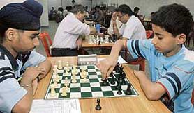 Himal (right) plays against Satbir Singh in the final of chess tournament at St Xaviers School in Sector 44, Chandigarh, on Sunday.