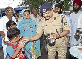 ITBP IG Ahmed Jamal Rasul distributes sweetened water on the occasion of the Martyrdom Day of Guru Arjan Dev in Chandigarh on Sunday.