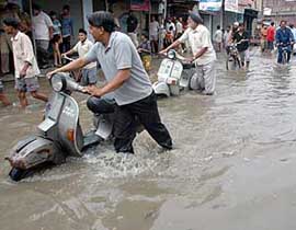 Motorists wade through waterlogged streets following heavy rainfall in Patiala on Sunday.
