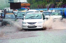Vehicles pass through the waterlogged Delhi-Gurgaon Highway (NH-8) in New Delhi. 