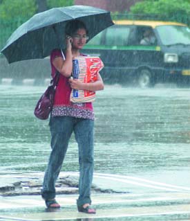 A girl tries to save herself from the showers with an umbrella at the ITO.
