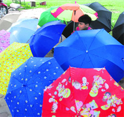 A vendor displays umbrellas of various hues and patterns to attract customers in Karnal on Sunday.