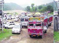 Stranded vehicles wait for their turn to cross the narrow Kotla-Soldha-Batees link road at Kotla. 