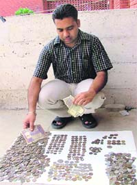 Hira Singh with his collection of coins