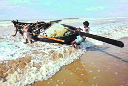 Fishermen drag their fishing boat in Digha, 200 km southwest of Kolkata, on Sunday.