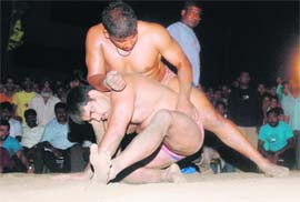 Wrestlers in action during the sixteenth annual wrestling competition organised by Peer Baba Meha Shah Ji Sports Club in Ludhiana on Monday.