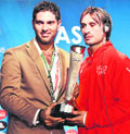 Yuvraj Singh hands over the Man of the match trophy to Swiss forward Hakan Yakin after the Euro 2008 Group A match between Switzerland and Portugal on Sunday at Jakob-Park stadium in Basel.