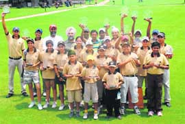 Winners and runners-up are all smiles as they hold their trophies after the conclusion of the National Junior Golf Camp in Chandigarh on Tuesday. Also seen in the picture are coach Jessie Grewal, assistant coach Mahesh Kumar and GGA general secretary J.S. Cheema. 