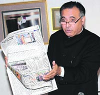 Former Congress minister G.S. Bali flashes The Tribune to buttress a point during a press conference at Shimla on Tuesday. 