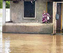 An aged man caught in flood waters in the Lakhimpur district of Assam on Monday.