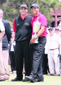 World number one Tiger Woods of the US laughs with runner-up and fellow American Rocco Mediate after winning on the first sudden death playoff hole during the playoff round of the 108th US Open at the Torrey Pines Golf Course in San Diego