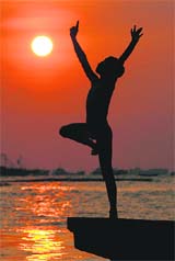 NATURES LAP: A child is silhouetted against the setting sun at Marunda beach in Jakarta, Indonesia.