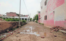 In the absence of proper roads, residents have to commute on kutcha pathways full of potholes and ditches in Saini Vihar, Baltana.